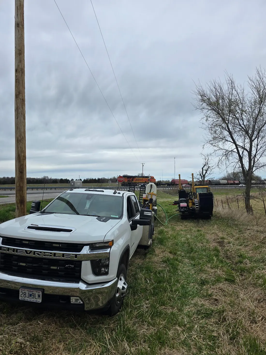 Bore rig and truck staged at a rail crossing