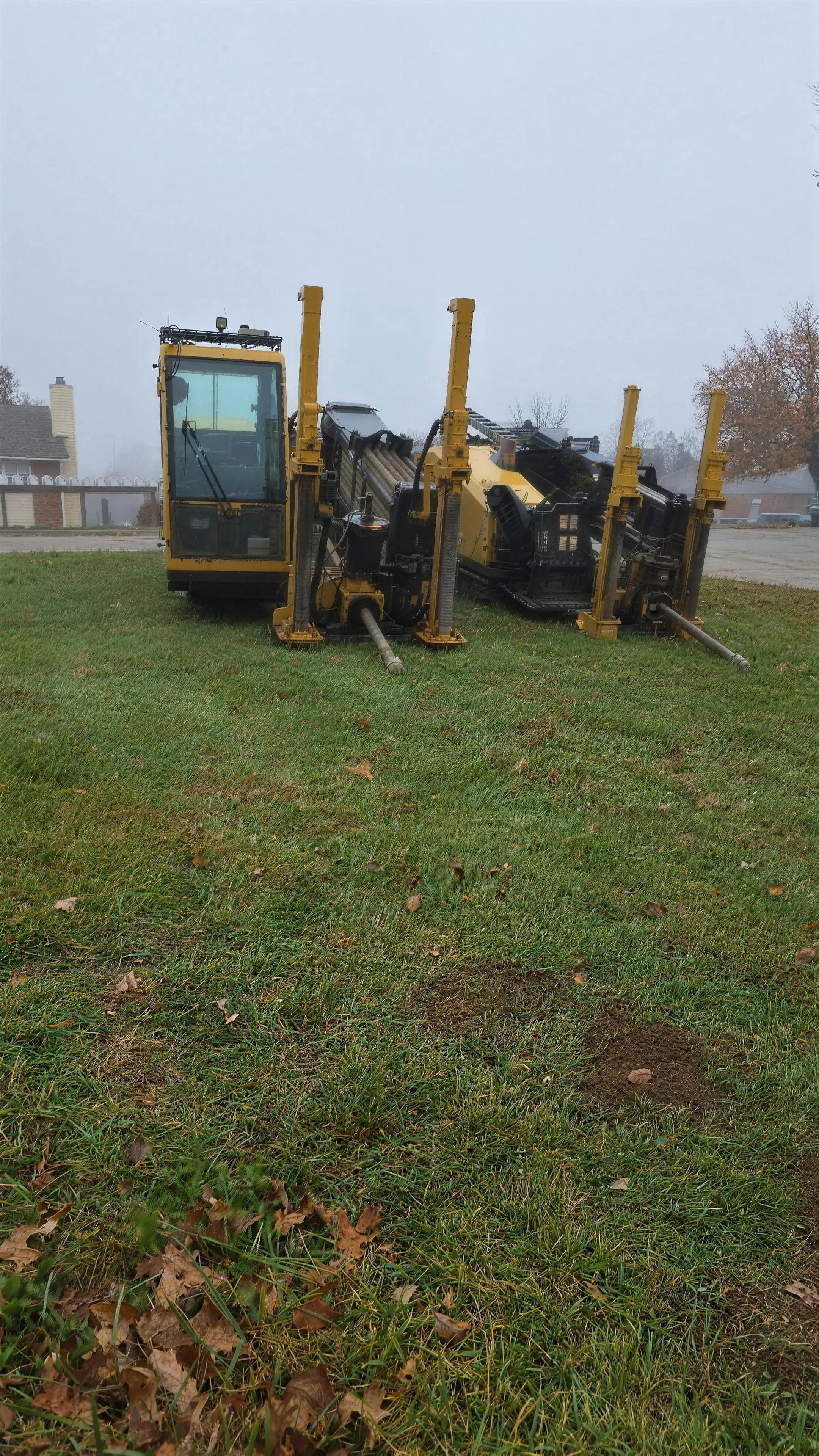 Two bore rigs staked in a residential yard
