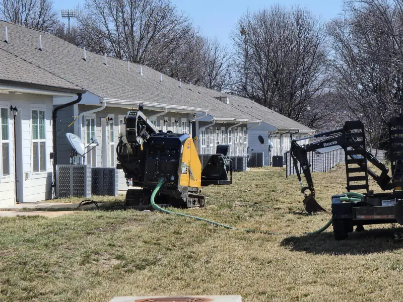 Excavator working a subdivision utility buildout