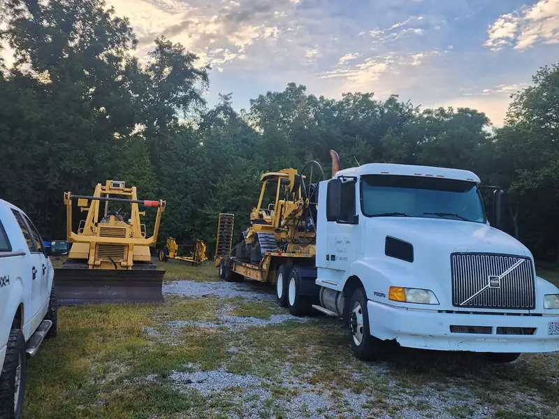 T&C Underground truck and lowboy trailer loaded with equipment