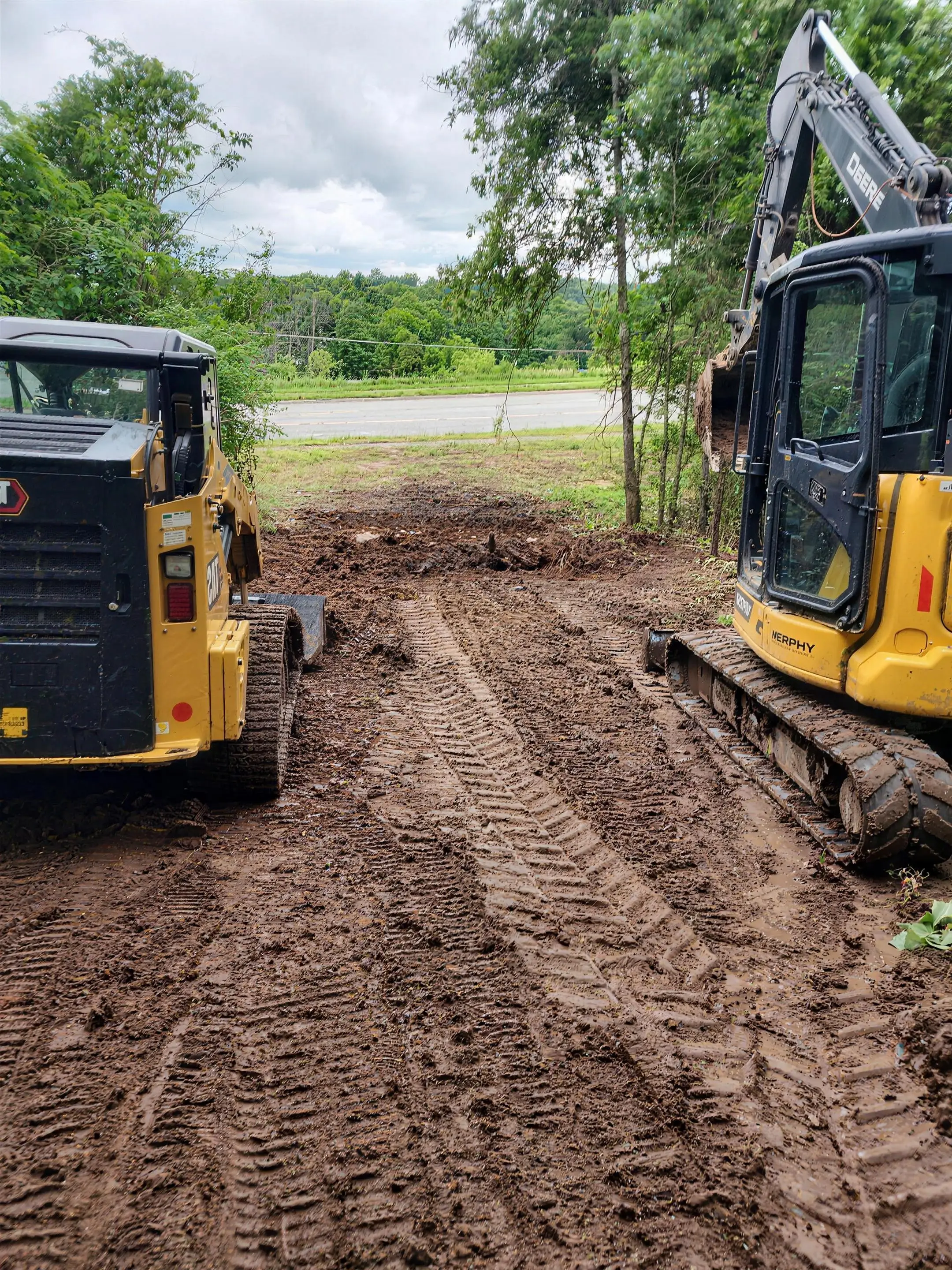 Skid steer and excavator on a dirt-work site