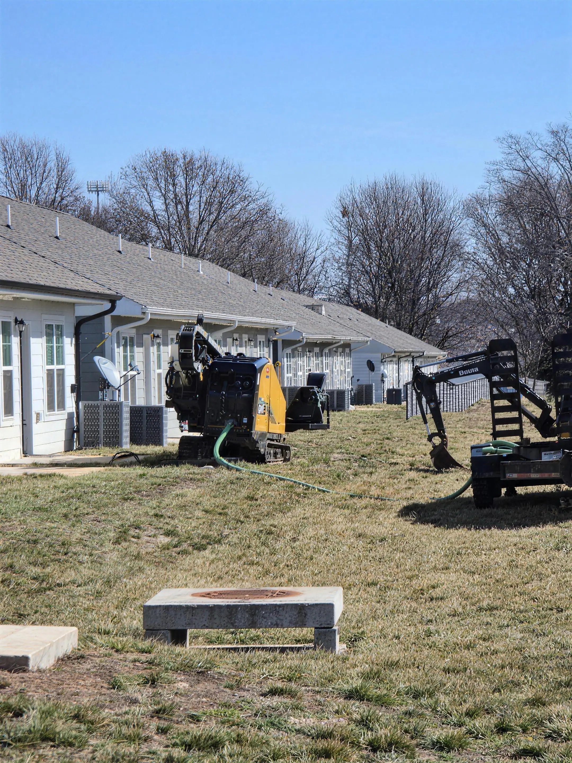 Drill rig and excavator on a subdivision buildout